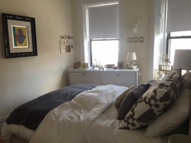 a bedroom with a bed and window