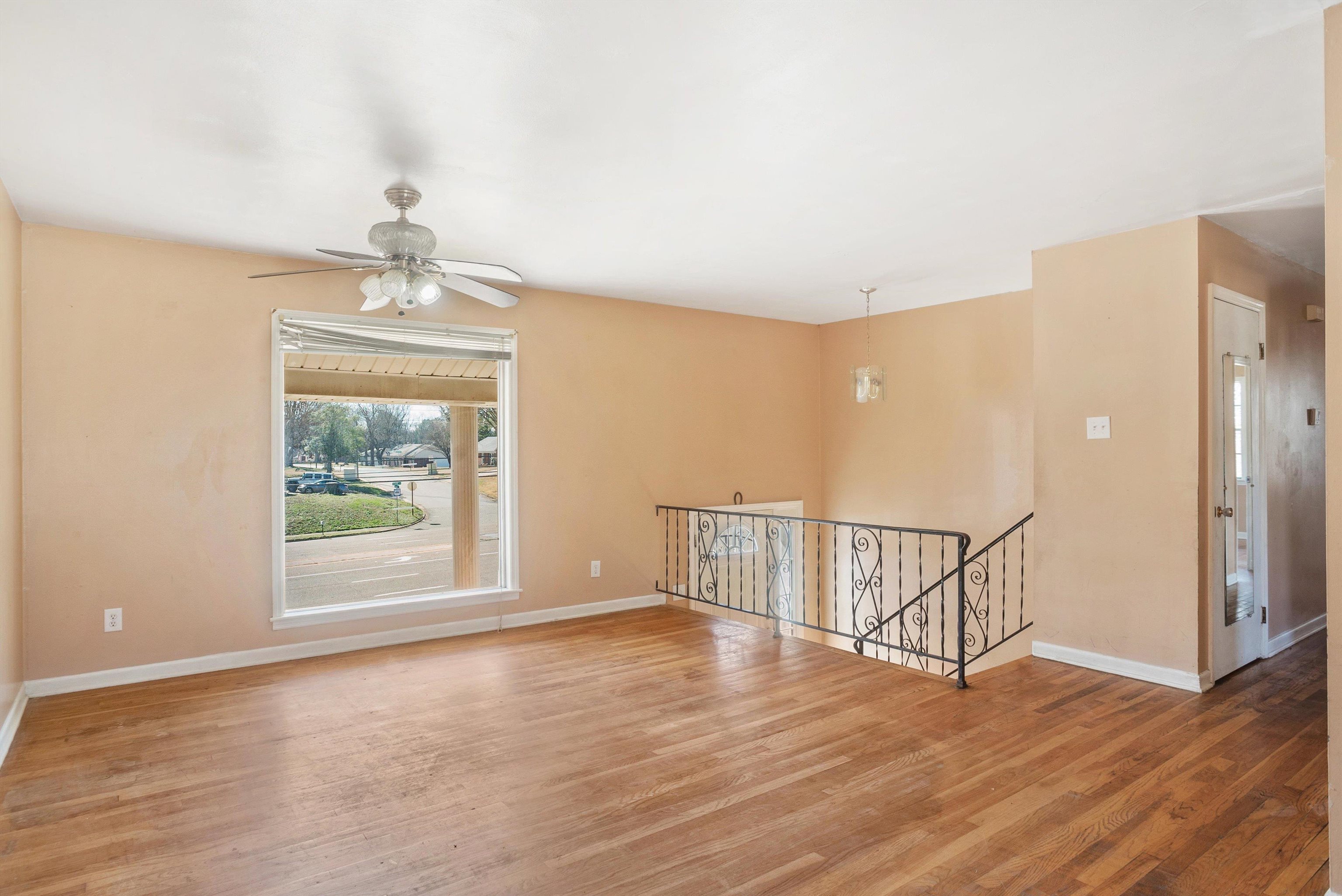 4696 Stage Road Memphis, TN 38128 - Photo 5 of 23 a view of an empty room with wooden floor and a window