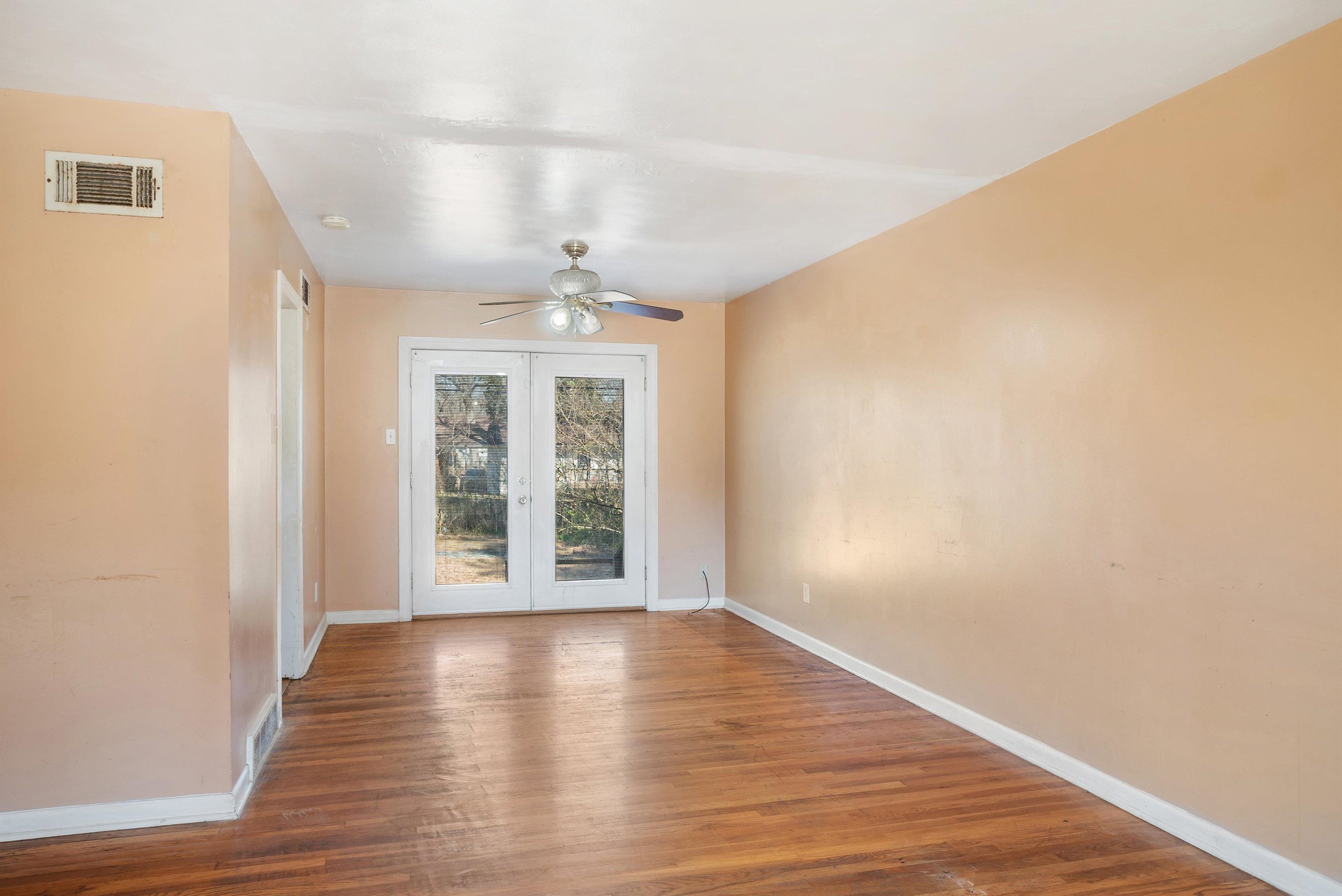 4696 Stage Road Memphis, TN 38128 - Photo 6 of 23 a view of an empty room with wooden floor and a window