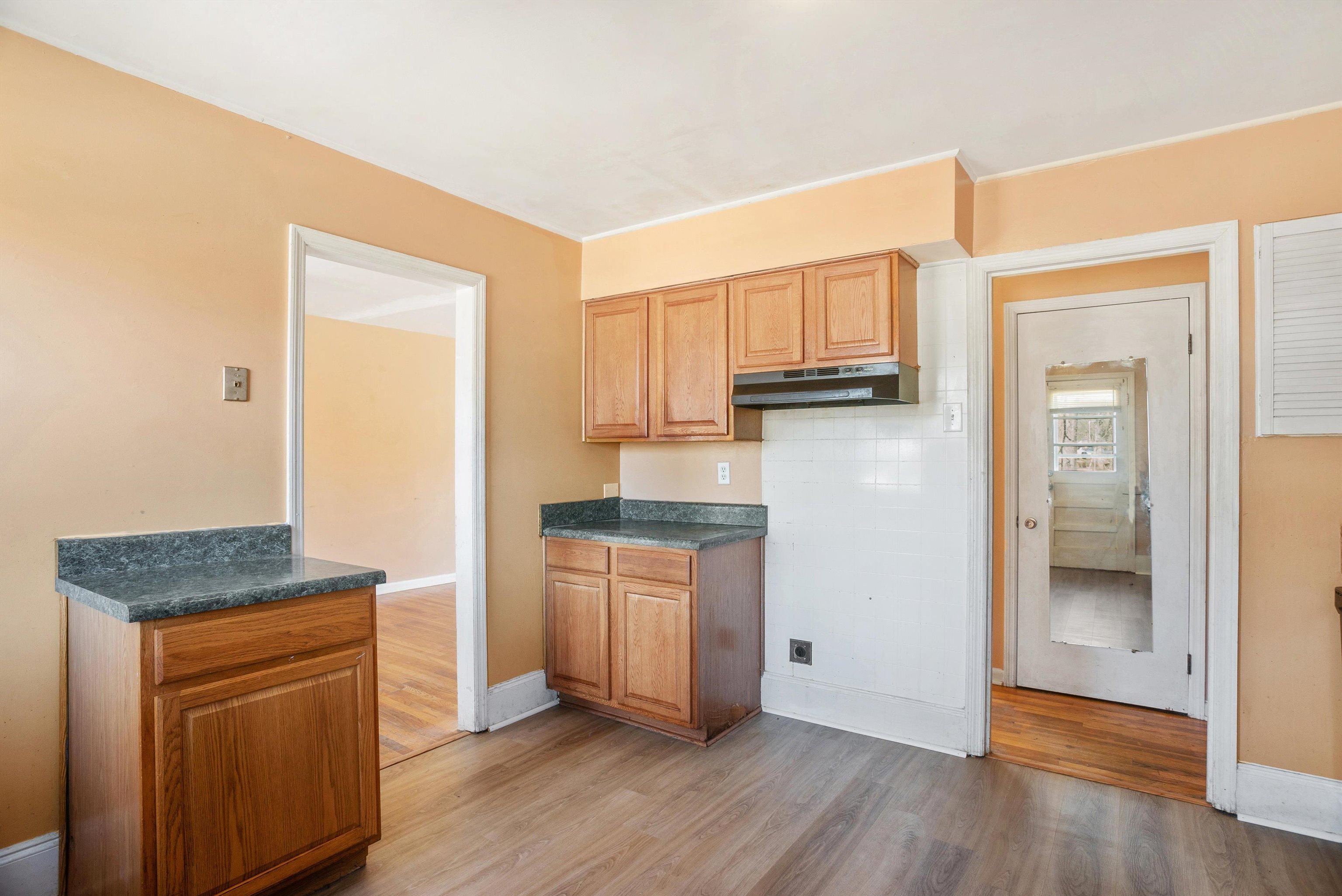 4696 Stage Road Memphis, TN 38128 - Photo 8 of 23 a kitchen with granite countertop wooden floors and stainless steel appliances