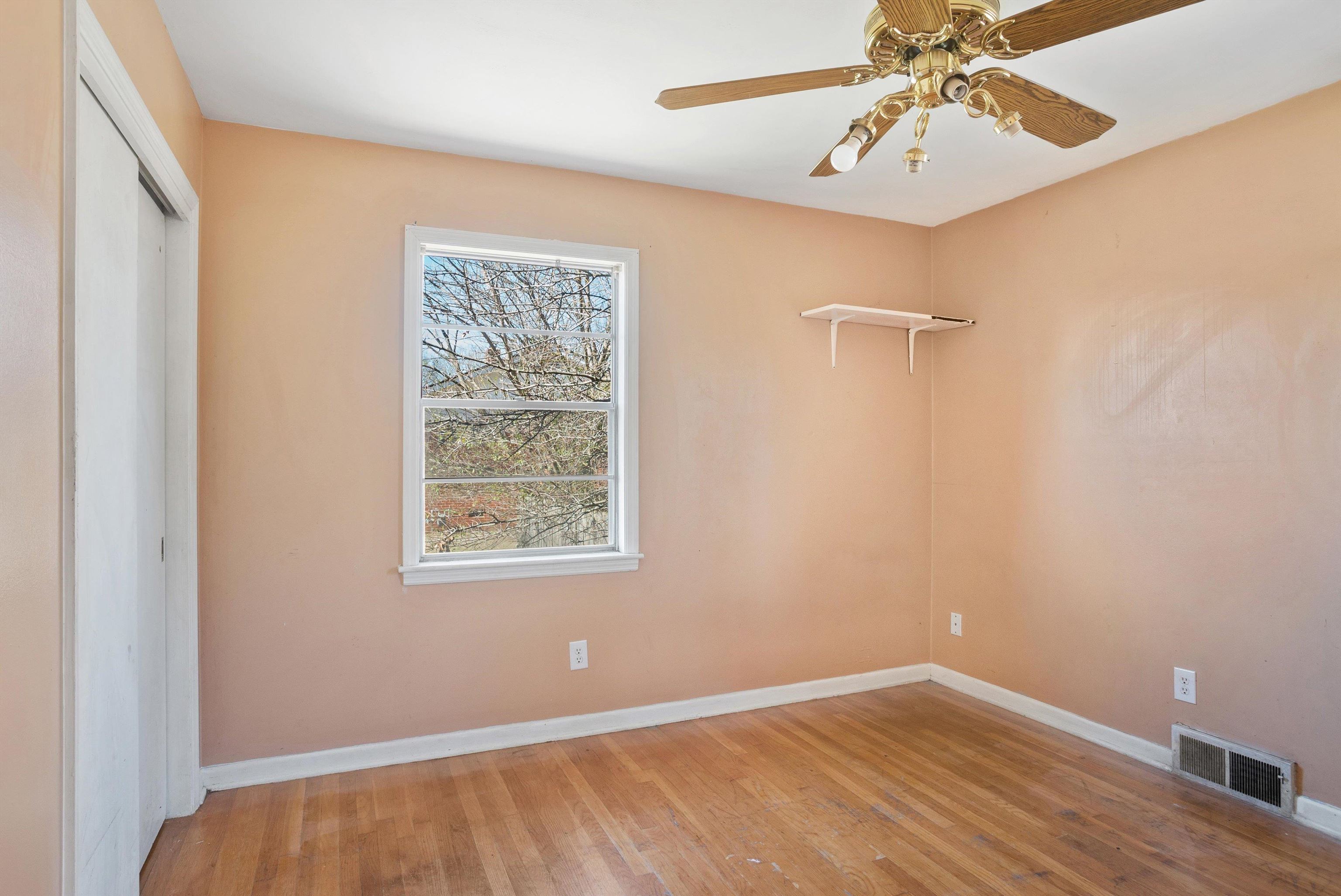 4696 Stage Road Memphis, TN 38128 - Photo 9 of 23 a view of an empty room with a window and a ceiling fan