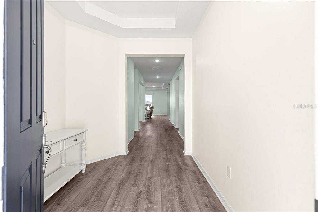 5851 Southwest 85th Place Ocala, FL 34476 - Photo 4 of 57 a view of a hallway with wooden floor