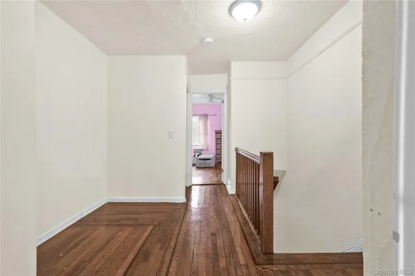 a view of hallway with wooden floor
