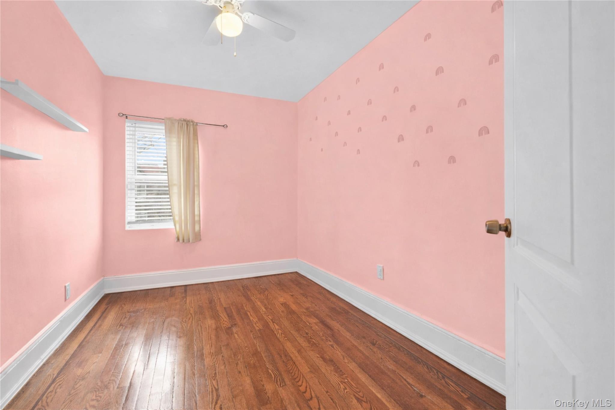 179-04 Selover Road Queens, NY 11434 - Photo 18 of 33 an empty room with wooden floor and windows