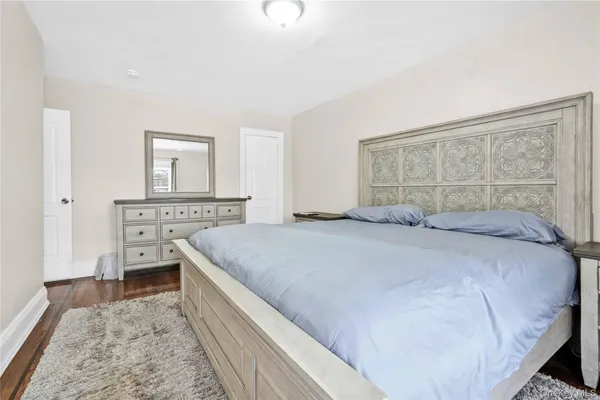 a bedroom with a bed and a dresser