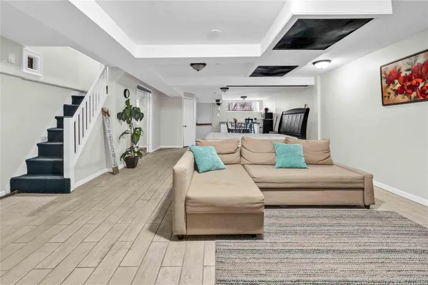 a living room with furniture and stairs