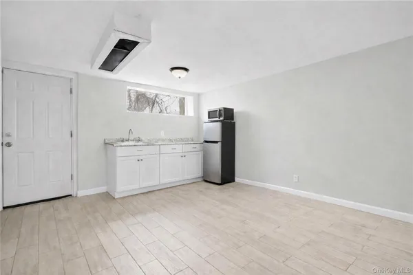 a kitchen with cabinets and window