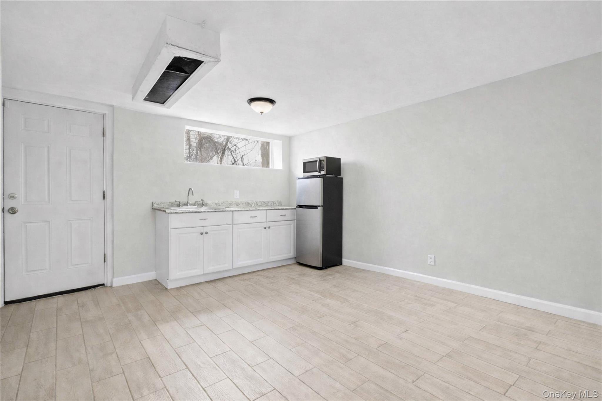 179-04 Selover Road Queens, NY 11434 - Photo 25 of 33 a kitchen with cabinets and window