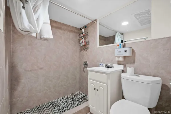 a bathroom with a sink toilet and a mirror