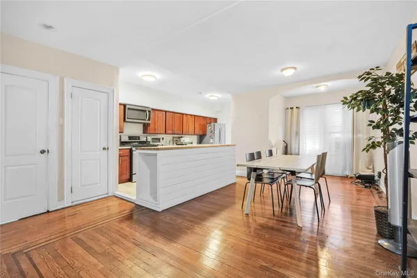 a kitchen with stainless steel appliances granite countertop a table and chairs in it