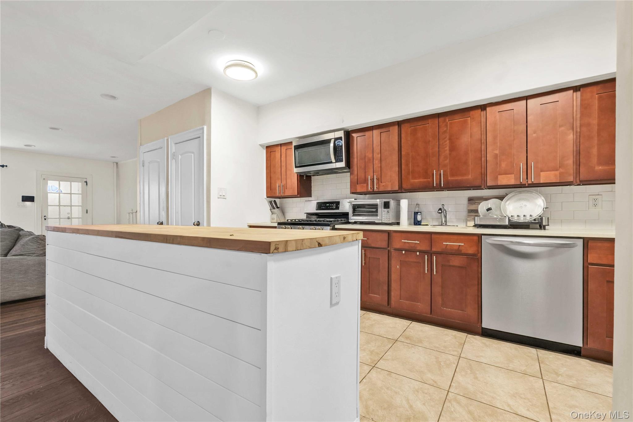 179-04 Selover Road Queens, NY 11434 - Photo 7 of 33 a kitchen with granite countertop a stove top oven sink and cabinets
