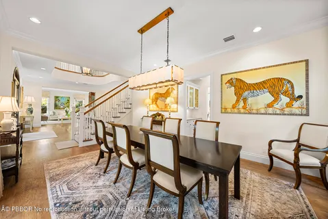 a dining room with furniture and a floor to ceiling window