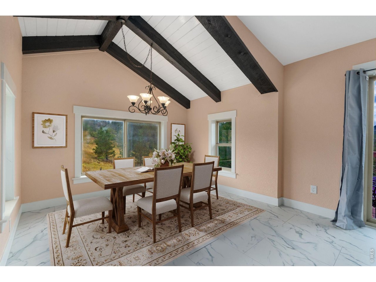 141 Tami Road Red Feather Lakes, CO 80545 - Photo 4 of 43 Dining nook with wraparound windows & beamed ceiling (virtually staged).