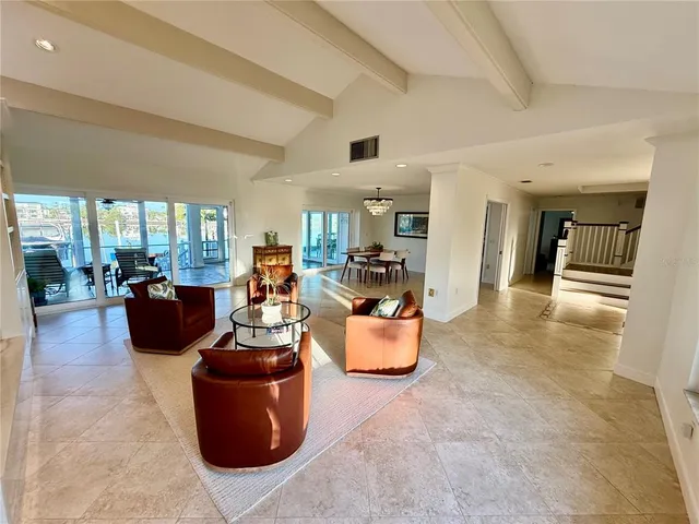 a living room with fireplace furniture and a large window
