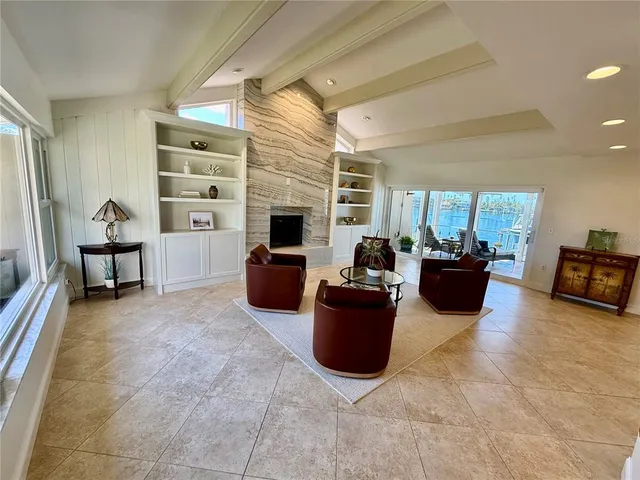 a view of a dining room with furniture a chandelier and wooden floor