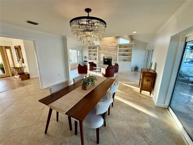 a view of a dining room with furniture and a chandelier
