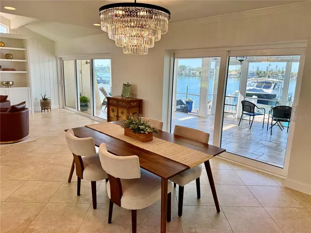 a dining room with furniture a chandelier and window