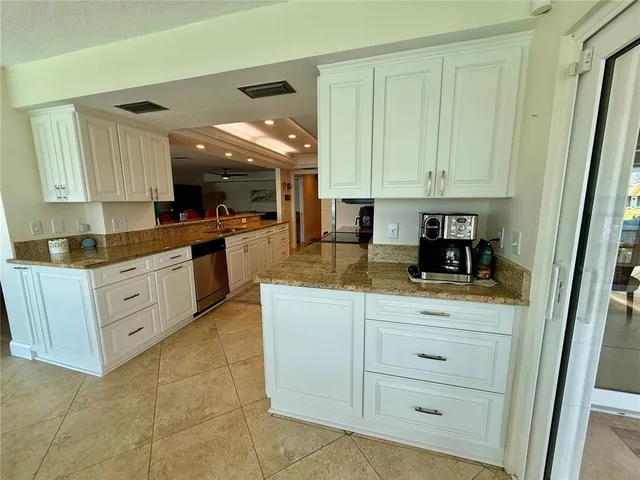 a bathroom with a granite countertop toilet sink and mirror