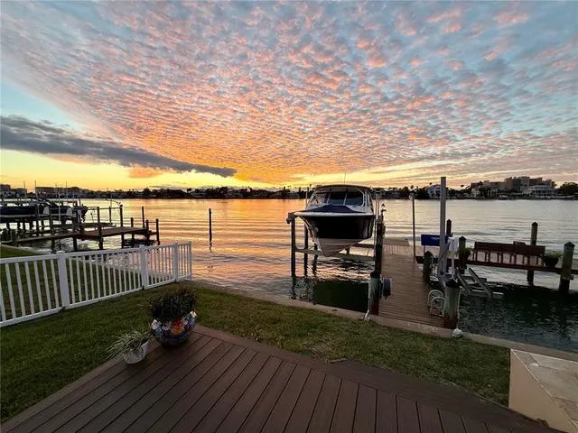a living room with furniture a fireplace and a large window