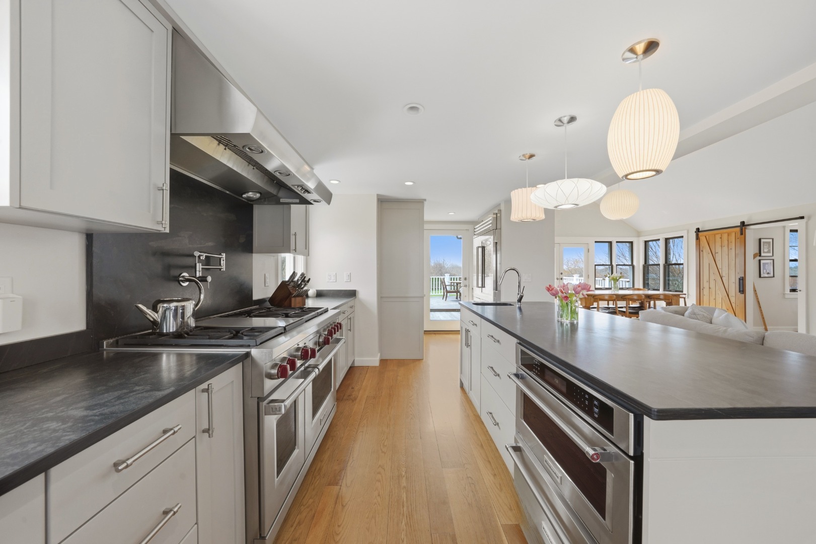247 Polpis Road Nantucket, MA 02554 - Photo 14 of 52 a kitchen with stainless steel appliances granite countertop a sink a stove and a wooden floors