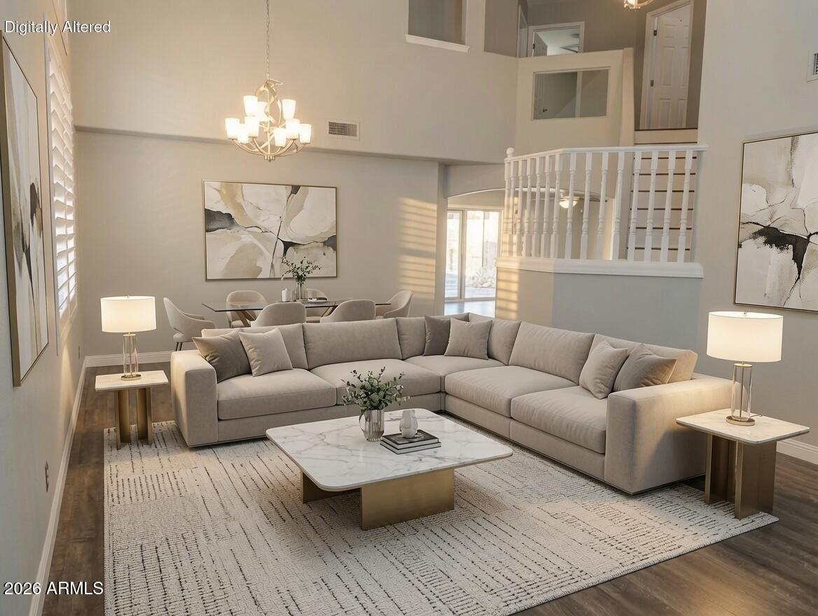 4409 East Dry Creek Road Phoenix, AZ 85044 - Photo 12 of 34 a living room with furniture and a chandelier