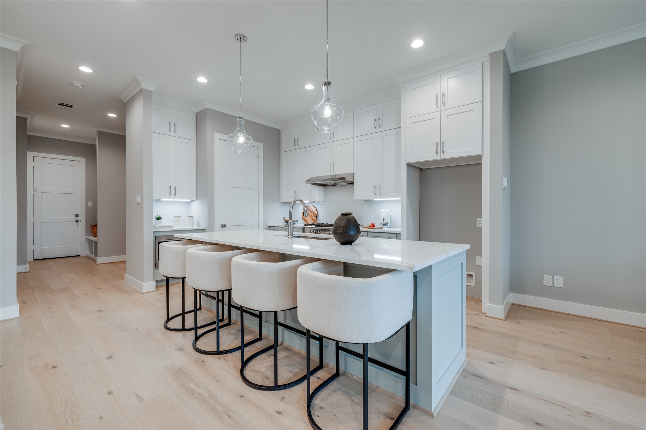 116 East 23rd Street Houston, TX 77008 - Photo 5 of 38 a kitchen with a dining table chairs cabinets wooden floor and appliances