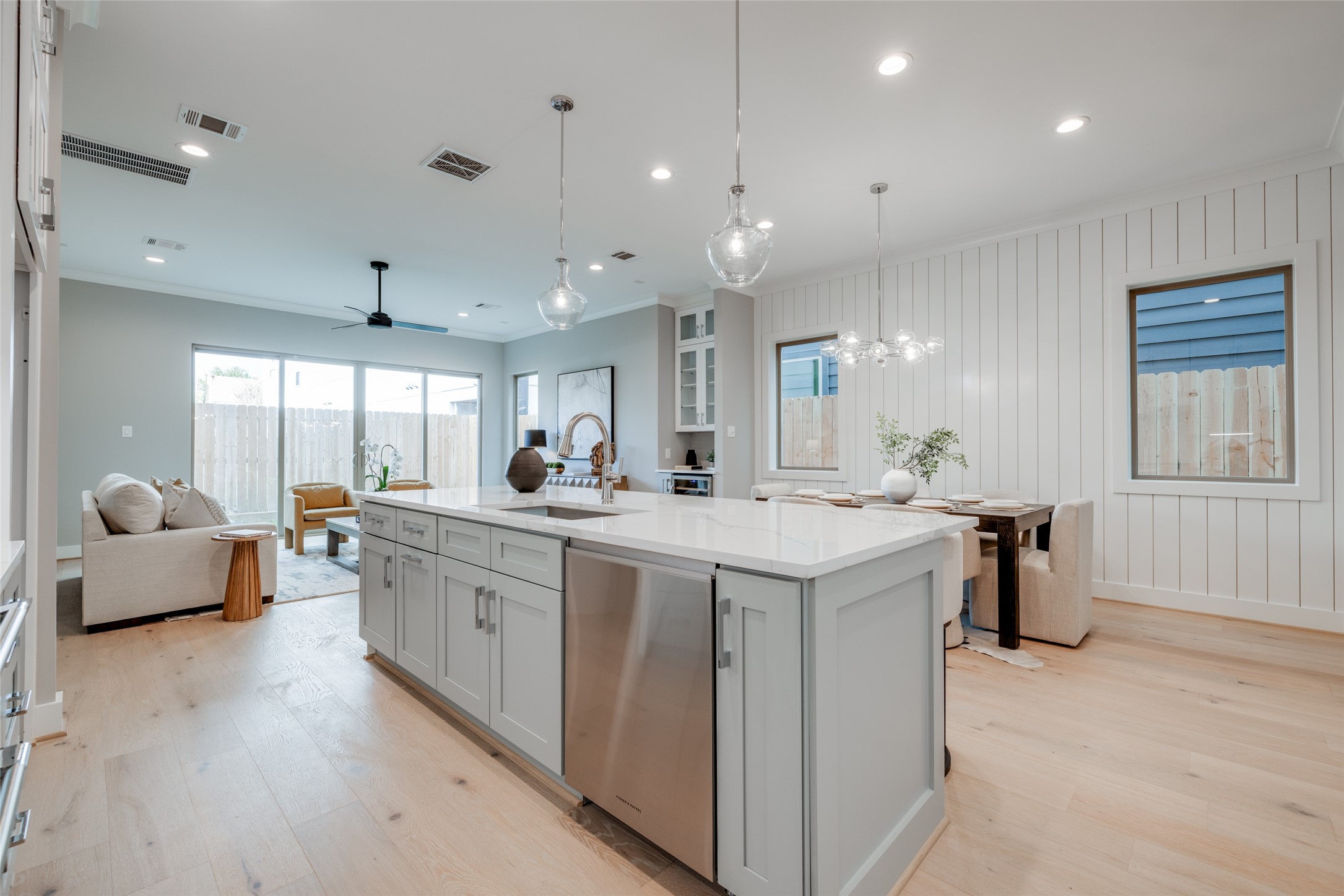 116 East 23rd Street Houston, TX 77008 - Photo 9 of 38 a large kitchen with kitchen island a sink a counter top space and living room view