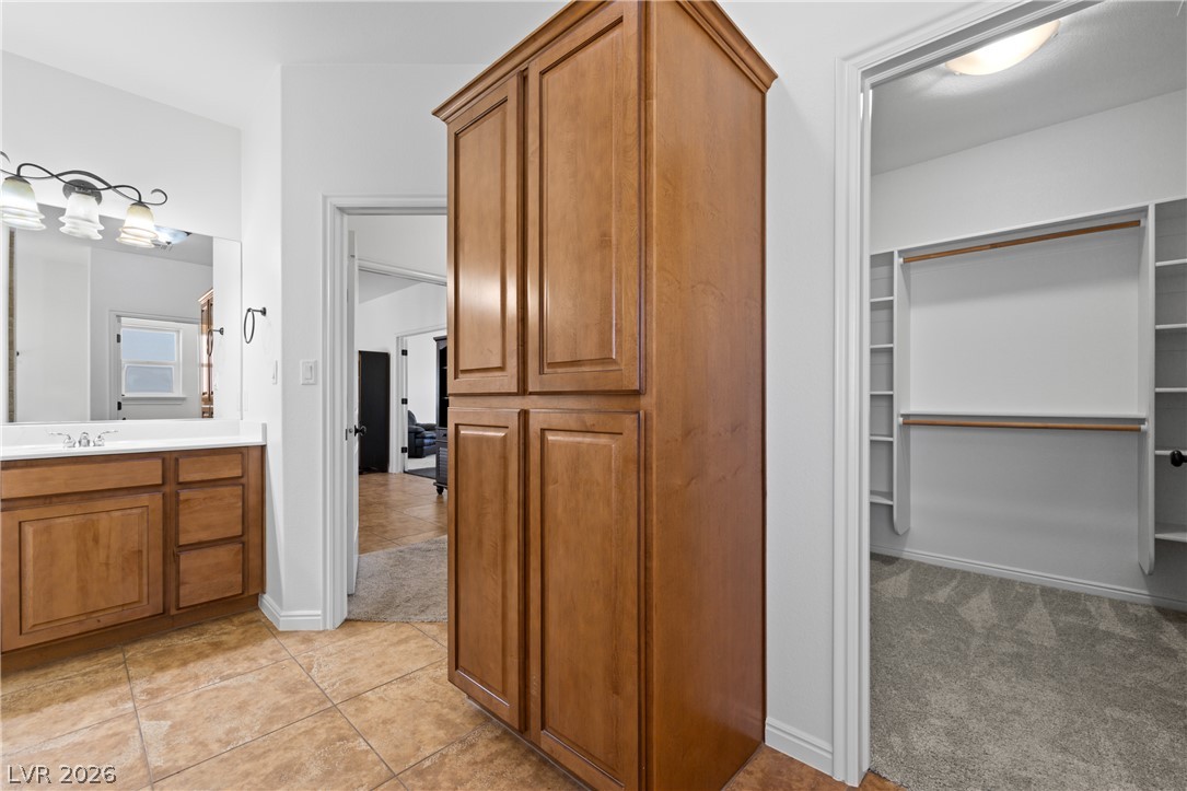 575 Gann Avenue Logandale, NV 89021 - Photo 37 of 75 A versatile space combining functional storage, a well-appointed bathroom vanity, and a spacious walk-in closet.