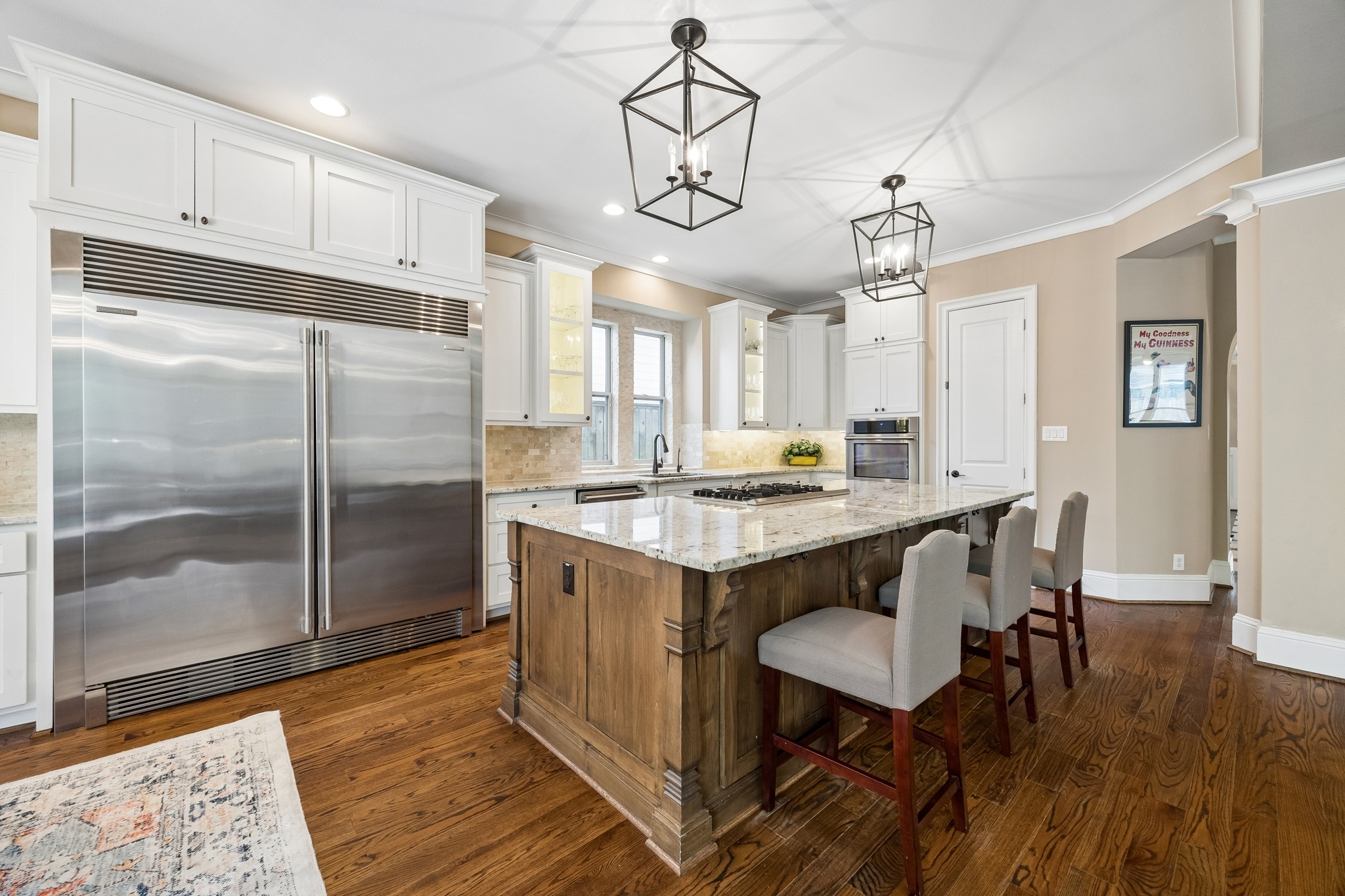 1360 Chippendale Road Houston, TX 77018 - Photo 7 of 34 Gourmet chef's kitchen anchored by an oversized granite island with breakfast bar seating and surrounded by extensive cabinetry and countertop workspace.