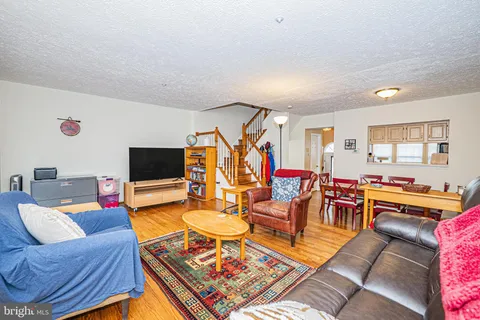 a living room with furniture a rug and a flat screen tv