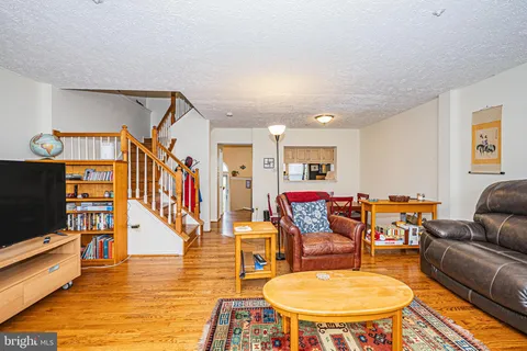 a living room with lots of furniture and kitchen view