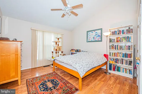a bedroom with a bed and a book shelf