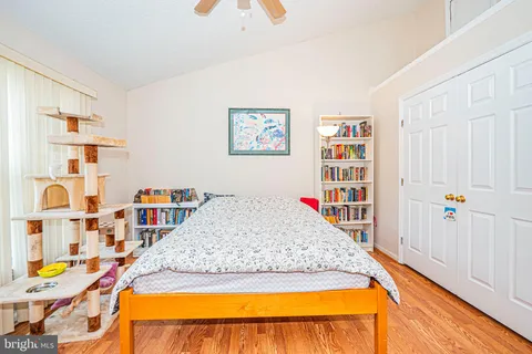 a bed sitting in a bedroom next to a book shelf