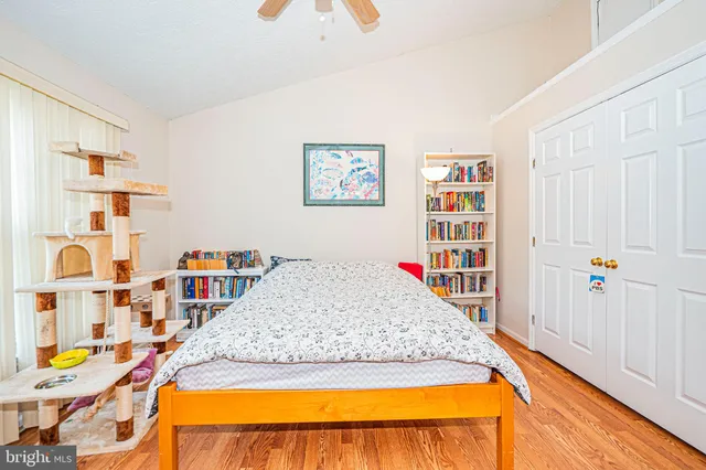 a bed sitting in a bedroom next to a book shelf