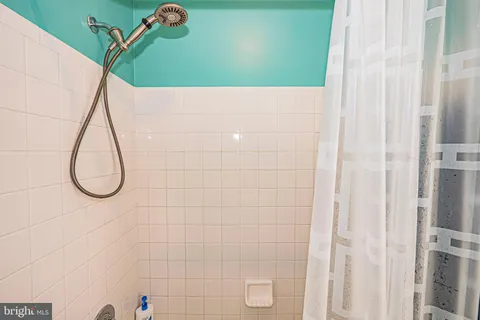 a picture of a bathroom with a shower
