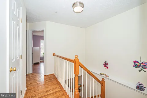 a view of a hallway to a house and wooden floor