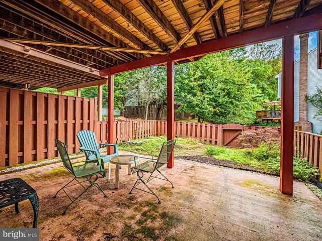 a chair and table sitting in front of a house