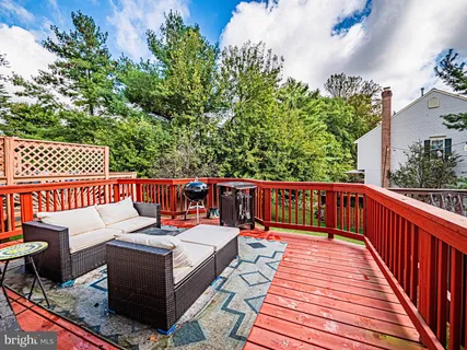 a balcony with wooden floor and furniture