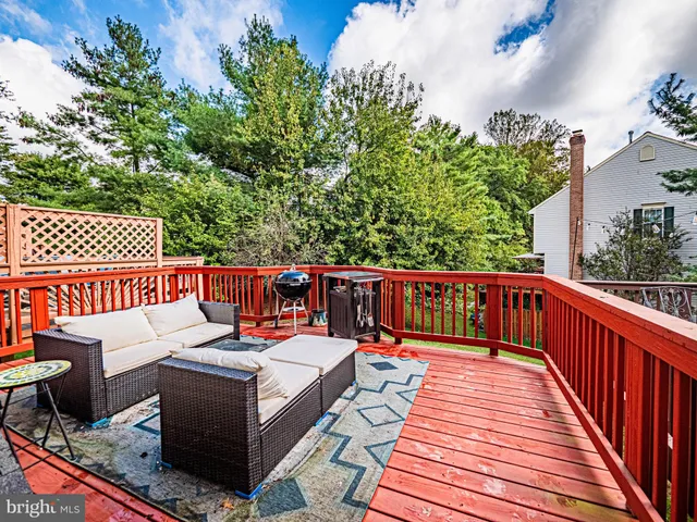 a balcony with wooden floor and furniture