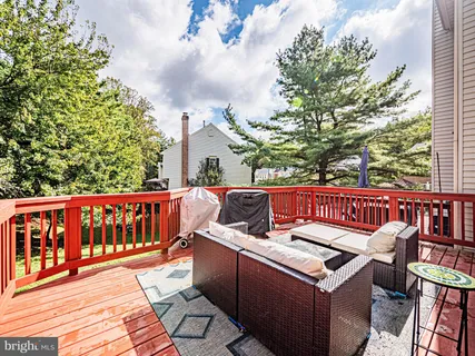 a view of roof deck with two chairs and a table