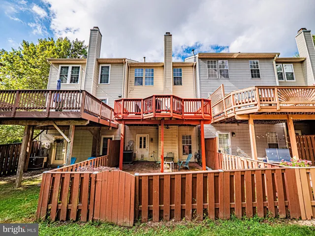 a front view of a house with a yard and deck