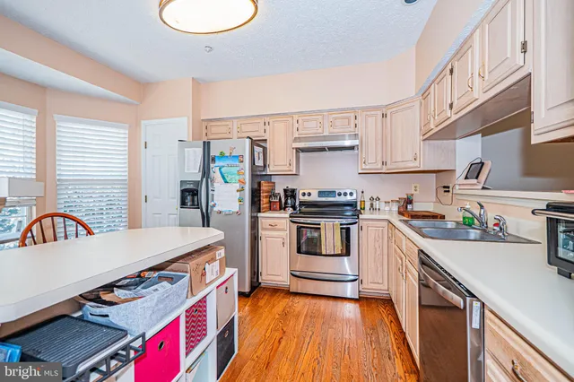 a kitchen with a stove a sink and a refrigerator