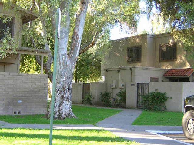 3947 West Wonderview Road Phoenix, AZ 85019 - Photo 1 of 1 a view of a yard in front of a house with a large tree