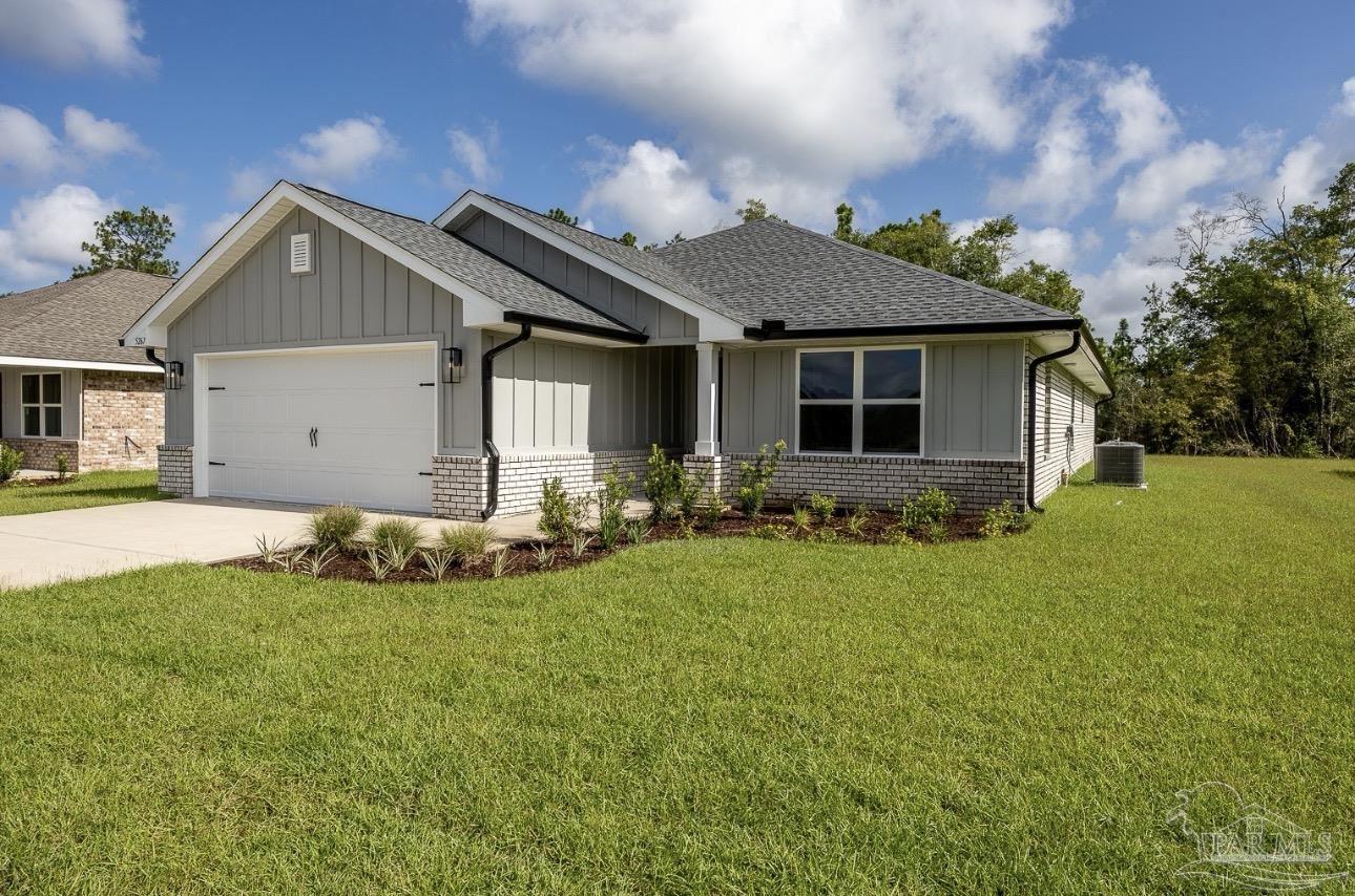 7657 Small Pnes Street Milton, FL 32583 - Photo 3 of 26 a view of a house with backyard and garden