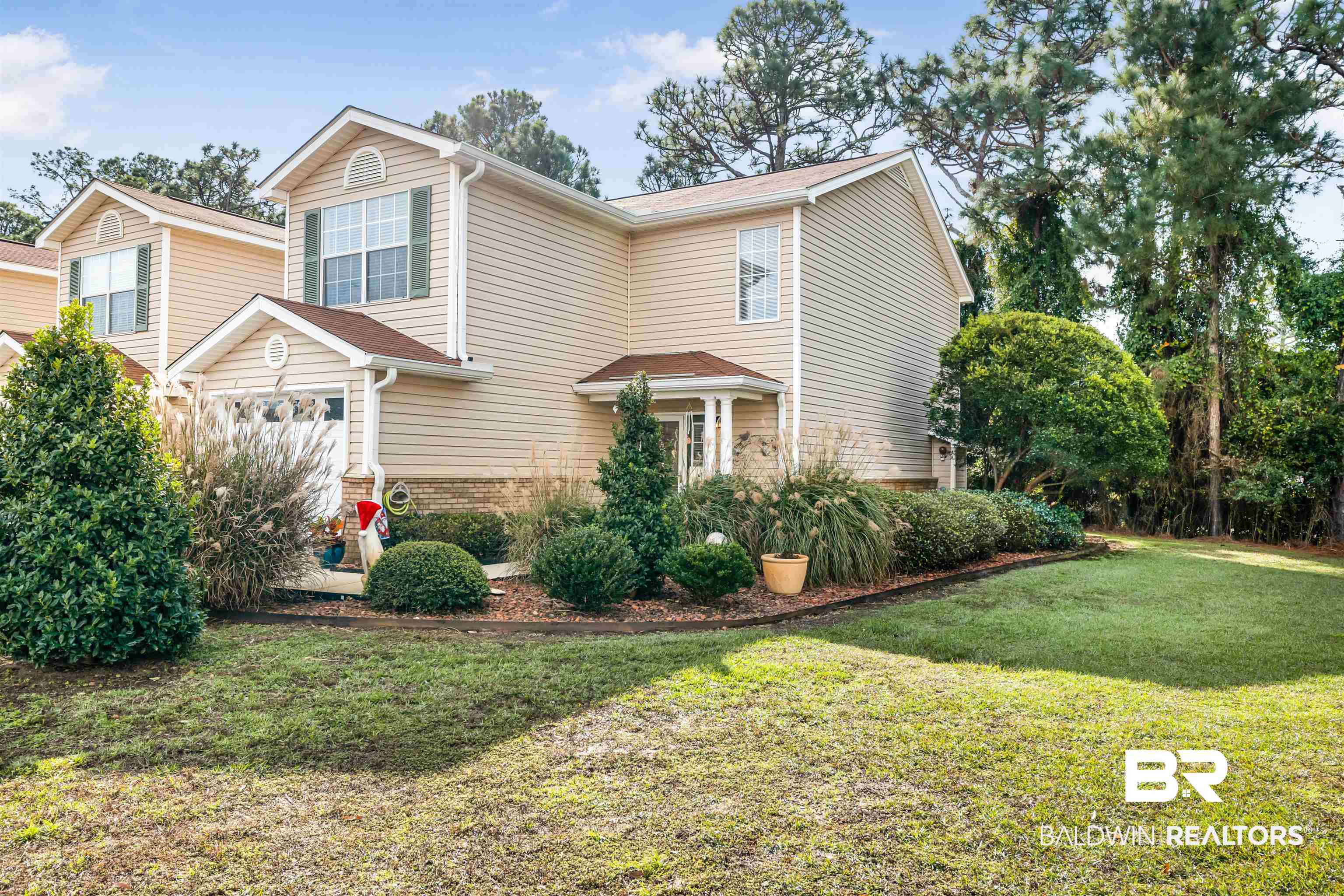 1517 Regency Road, Unit 68 Gulf Shores, AL 36542 - Photo 2 of 43 View of front of home with a front lawn