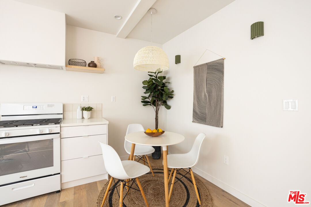 1946 Preston Avenue Los Angeles, CA 90026 - Photo 2 of 13 a kitchen with stainless steel appliances white cabinets and wooden floor