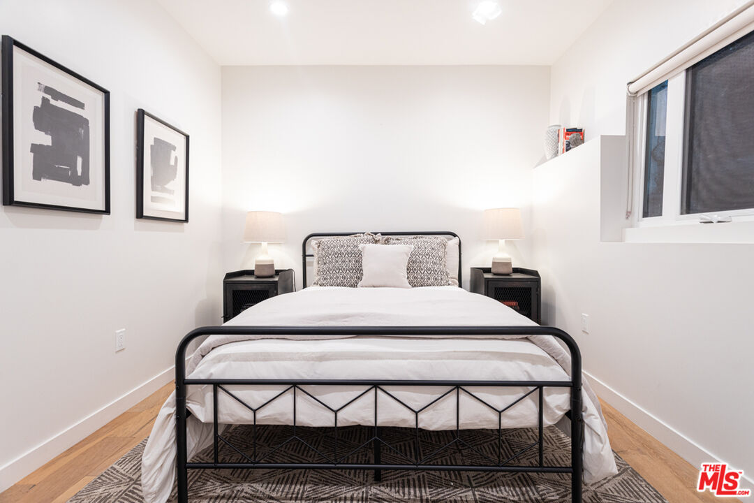 1946 Preston Avenue Los Angeles, CA 90026 - Photo 9 of 13 a bedroom with a bed and wooden floor