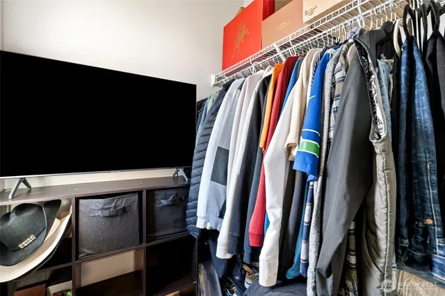 a view of walk in closet with clothes and shoes
