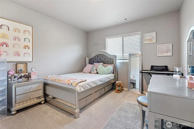 a bedroom with a bed and a couch