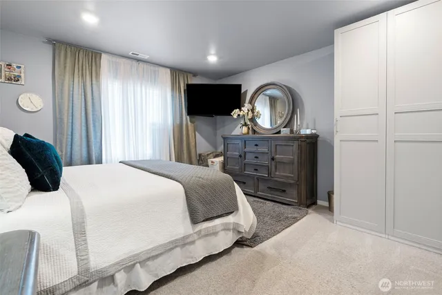 a bedroom with a bed and a dresser